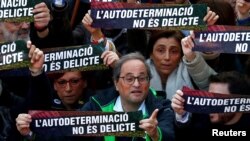 FILE - Catalan Regional President Quim Torra takes part during a rally of Catalan separatist organizations to demonstrate against the trial of Catalan leaders and call for self-determination rights in Barcelona, Spain, Feb. 16, 2019.
