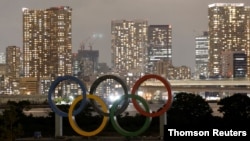 FILE - Olympic rings are installed on a floating platform ahead of the 2020 Olympic Games in Tokyo.