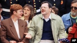 FILE - Terry Anderson holds an American flag presented to him while sitting with his sister Peggy Say during a ceremony in his honor at Dulles International Airport in Chantilly, Virginia, Dec. 12, 1991. Say died at age 74, Dec. 23, 2015.