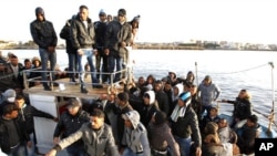 Migrants from North Africa arrive in the southern Italian island of Lampedus, March 7, 2011