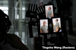 A director looks at vertical screens on the set of a microfilm during a filming session at a hospital in Zhengzhou, China, July 17, 2024. (Reuters/Tingshu Wang)