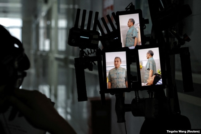 A director looks at vertical screens on the set of a micro movie during a filming session at a hospital, in Zhengzhou, China, July 17, 2024. (Reuters/Tingshu Wang)