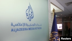 The Al Jazeera Media Network logo is seen inside its headquarters in Doha, Qatar, June 8, 2017. Israeli officials confirmed on March 30, 2024, the killings of two Palestinian men by Israeli troops on Gaza's beach, shown in a video broadcast by Al Jazeera.