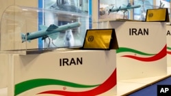 (FILE) Models of Iranian missiles are seen at a stand at the DIMDEX exhibition in Doha, Qatar.