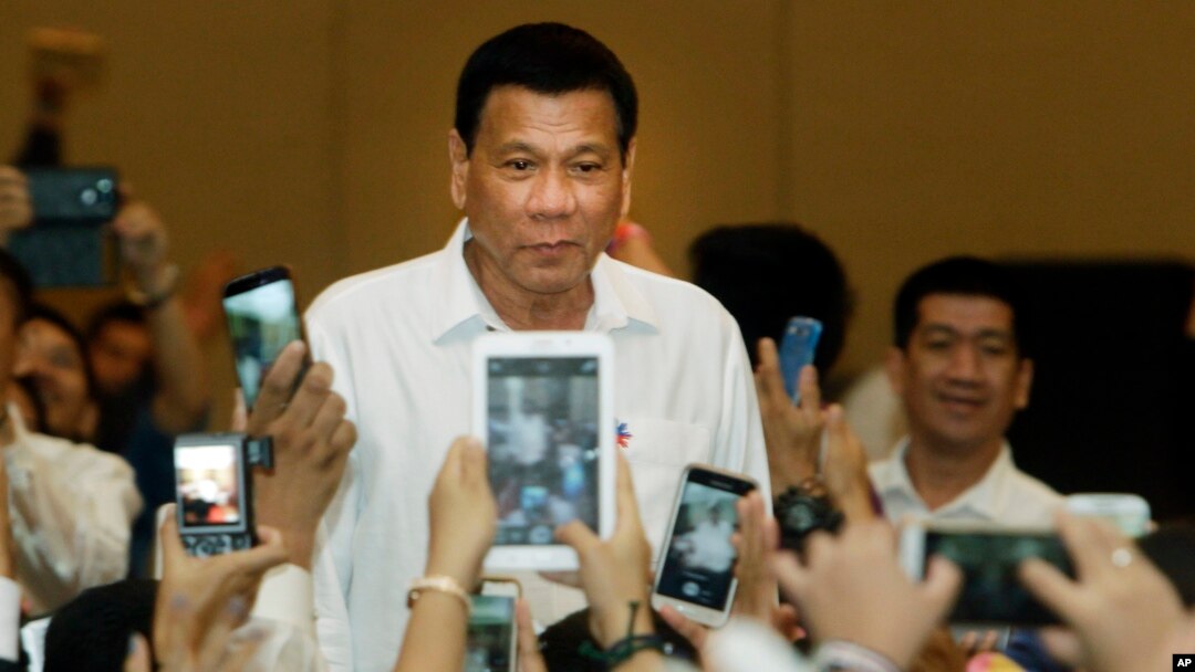 Philippine President Rodrigo Duterte, arrives a meeting with the Filipino community, in Phnom Penh, Cambodia, Dec. 13, 2016. 