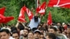 Supporters of the Jammu and Kashmir National Conference party shout slogans as they celebrate outside the vote counting centre on the day of the assembly election results, in Srinagar, Oct. 8, 2024. 