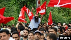 Supporters of the Jammu and Kashmir National Conference party shout slogans as they celebrate outside the vote counting centre on the day of the assembly election results, in Srinagar, Oct. 8, 2024. 