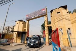 A police vehicle moves through the entrance of the Central Prison in Karachi, Pakistan, Jan. 28, 2021.