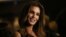 FILE - Model Cindy Crawford poses for photographs on arrival at her book launch at the Beaumont Hotel in central London, Oct 1, 2015. 