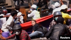 Angel, a 19-year-old protester, also known as Kyal Sin, lies on the ground before she was shot in the head as Myanmar's forces opened fire to disperse an anti-coup demonstration in Mandalay, March 3, 2021.