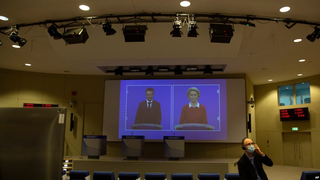 European Commission President Ursula von der Leyen, right, speaks via video conference into a press room at EU headquarters in Brussels, Oct. 28, 2020, launching an additional set of actions, to help limit the spread of the coronavirus.