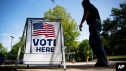 FILE - A voter leaves a polling site after casting a ballot in a special election in Marietta, Ga.