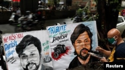FILE - An artist applies finishing touches to a painting in memory of Reuters journalist Danish Siddiqui, outside an art school in Mumbai, India, July 16, 2021.
