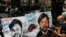 FILE - An artist applies finishing touches to a painting in memory of Reuters journalist Danish Siddiqui, outside an art school in Mumbai, India, July 16, 2021.