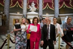House Speaker Nancy Pelosi of Calif., center, walks to the House floor from her office on Capitol Hill, June 27, 2019.