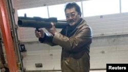 Takeshi Ebisawa poses with a rocket launcher during a meeting with an informant and two undercover Danish police officers at a warehouse in Copenhagen, Denmark, Feb. 3, 2021, in a photograph from a criminal complaint. (Southern District of New York/Handout via Reuters). 