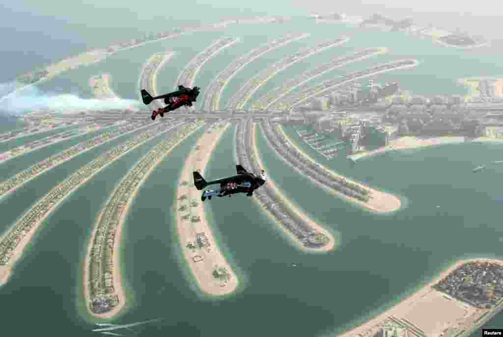 An aerial view taken from a sea plane shows Swiss pilot and original Jetman Yves Rossy (f) and Vince Reffett flying over Dubai&#39;s Palm Island, Dubai, United Arab Emirates.