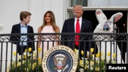 U.S. President Donald Trump stands with his son Barron, first lady Melania Trump and the Easter Bunny at the White House, April 17, 20017.