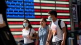 People wear masks around Times Square, as cases of the infectious coronavirus Delta variant continue to rise in New York City, New York, U.S., July 23, 2021. REUTERS/Eduardo Munoz