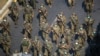 FILE PHOTO: Myanmar soldiers walk along a street during a protest against the military coup in Yangon, Myanmar, February 28, 2021. REUTERS/Stringer/File Photo