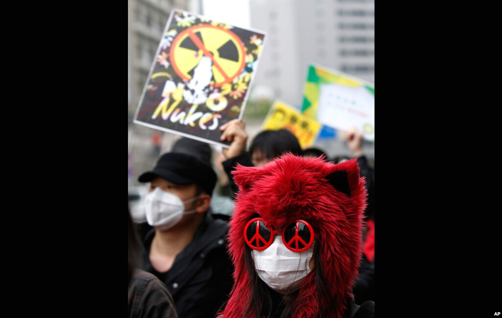 Participants wear masks at a parade demanding a stop to all nuclear power plants in Japan as part of an event for Earth Day in Tokyo April 22, 2012. (Reuters) 