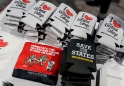 FILE - Supporters of the Electoral College display items at the Conservative Political Action Conference's annual meeting at National Harbor in Oxon Hill, Md., Feb. 27, 2020.
