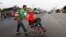 Nicaraguan migrant Javier Velazquez wheels his 14-year-old son across a highway, as part of the Central American migrant caravan hoping to reach the U.S. border, in Acayucan, Veracruz state, Mexico, Nov. 3, 2018. Javier Velazquez said that Axel was shot 