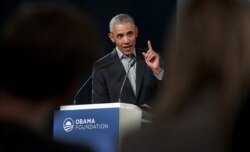 FILE - Former U.S. President Barack Obama gestures as he speaks during a town hall meeting at the European School For Management And Technology in Berlin, Germany, April 6, 2019.