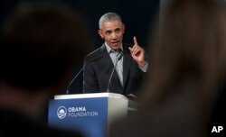 FILE - Former U.S. President Barack Obama gestures as he speaks during a town hall meeting at the European School For Management And Technology in Berlin, Germany, April 6, 2019.