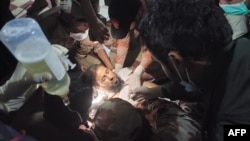 Paramedics treat the injured at Mach railway station, which was been turned into a makeshift hospital after Pakistani security forces freed nearly 80 passengers following a security operation against militants who ambushed the train in Balochistan province, March 11, 2025.