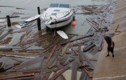 Shawn Pugsley surveys the damage to a private marina after it was hit by Hurricane Hanna, Sunday, July 26, 2020, in Corpus Christi,Texas. Nolan's boat and about 30 others were lost or damaged in the…