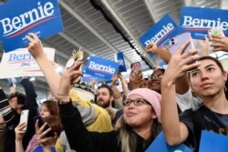 People listen as Democratic presidential candidate Sen. Bernie Sanders, I-Vt., speaks at a campaign rally in Springfield, Va., Feb. 29, 2020.