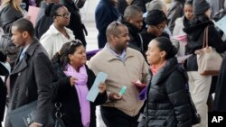 FILE - A crowd of job seekers attends a health care job fair in New York, March 14, 2013.