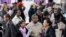 FILE - A crowd of job seekers attends a health care job fair in New York, March 14, 2013.