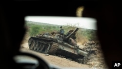 FILE: FILE - A destroyed tank is seen south of Humera, an area of western Tigray annexed by Amhara during the ongoing conflict, on May 1, 2021. The warring sides agreed to a end to hostilities on Nov. 2, 2022, but NGO HRW reports "ethnic cleansing" in western Tigray.. 