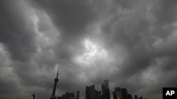 Dark clouds cover the financial district of Shanghai, August 6, 2011, as typhoon Muifa approaches the Chinese province of Zhejiang