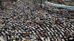 Protesters conduct Friday Prayers in Tahrir square in Cairo. Thousands of Egyptians converged on Cairo's Tahrir square on Friday in what organizers called a "second revolution" to push for deeper reforms and a speedy trial for ousted President Hosni Mubar