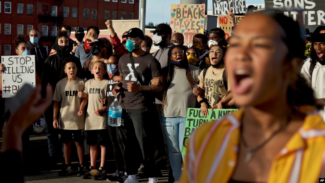Portland Trail Blazers' Damian Lillard, center, joins other demonstrators in Portland, Ore., during a protest against police, sparked by the death of George Floyd, who died May 25 after being restrained by police in Minneapolis. (AP)