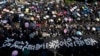 Protesters carrying umbrellas and a huge banner reading 'Hong Kong police deliberate murder' march on a street in Hong Kong, Oct. 20, 2019. Authorities are beefing up security ahead of an unauthorized rally by pro-democracy protesters.