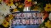 FILE - Pictures of Wednesday's shooting victims are displayed at a makeshift memorial site in San Bernardino, Calif., Dec. 7, 2015.