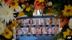 FILE - Pictures of Wednesday's shooting victims are displayed at a makeshift memorial site in San Bernardino, Calif., Dec. 7, 2015.