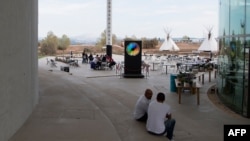 FILE - People sit at "thecamp," a campus dedicated to emerging technology and social innovation, on its opening day in Aix-en-Provence, southern France, Sept. 28, 2017. Scores of universities worldwide teach students about social enterprises, typically through work placements or incubating their startups.