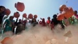 Women throw earthern pitchers onto the ground to protest against the shortage of drinking water outside the municipal corporation office in Ahmedabad, India.