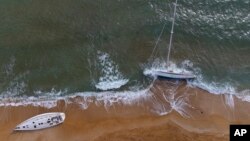 Sailboats used by smugglers to transport migrants and refugees are beached on Le Cannelle beach in Isola Capo Rizzuto, Calabria region, Southern Italy, Nov. 13, 2021. 