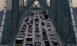 FILE - Vehicles make their way west on Interstate 80 across the San Francisco-Oakland Bay Bridge as seen from Treasure Island in San Francisco, Dec. 10, 2015.