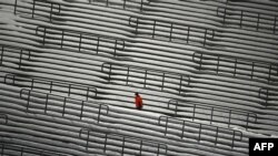 A ski jump staff member walks at empty stands during the second competition jump of the FIS Men&#39;s Ski Jumping World Cup in Willingen, western Germany, Jan. 30, 2021.