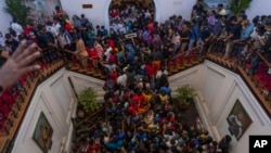 People occupy President Gotabaya Rajapaksa’s official home for the second day in Colombo, Sri Lanka, Monday, July 11, 2022. (AP Photo/Rafiq Maqbool)
