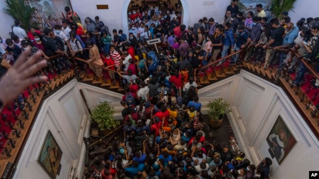 People occupy President Gotabaya Rajapaksa’s official home for the second day in Colombo, Sri Lanka, Monday, July 11, 2022. (AP Photo/Rafiq Maqbool)