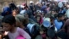 FILE - Palestinians line up for food distribution in Deir al-Balah, Gaza Strip, on Oct. 17, 2024.