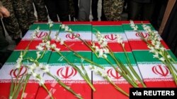 Coffins of four Iranian victims of the downing by Iran of a Ukrainian airliner are seen during the victims' funeral in Hamadan, Iran, Jan. 16, 2020.